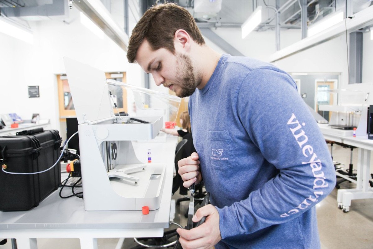 Higher Education Student Using 3D Printer